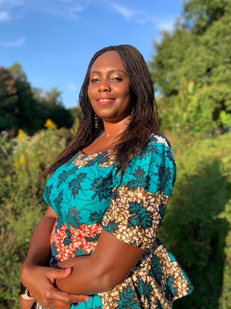a woman in front of a field