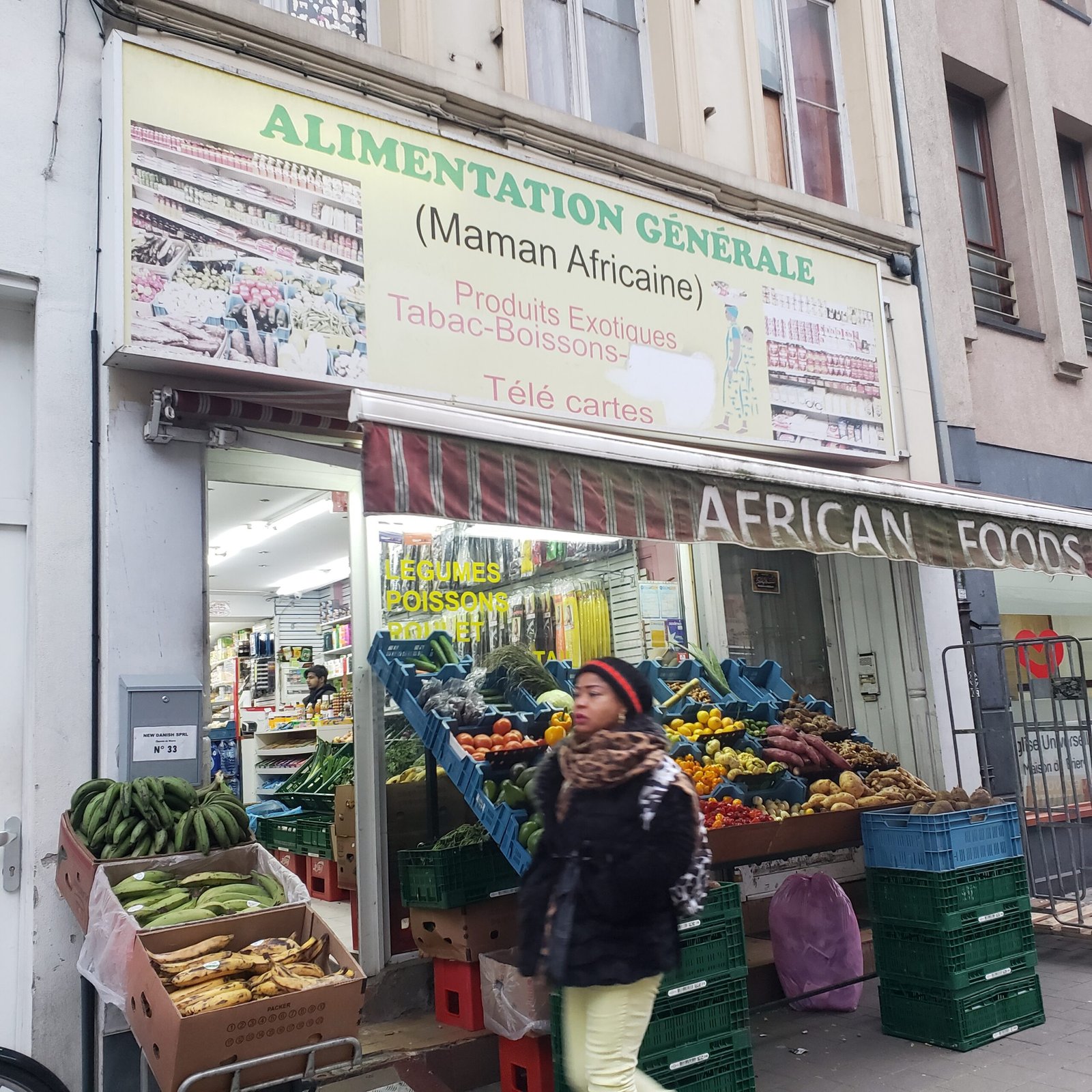 a woman walks past a market