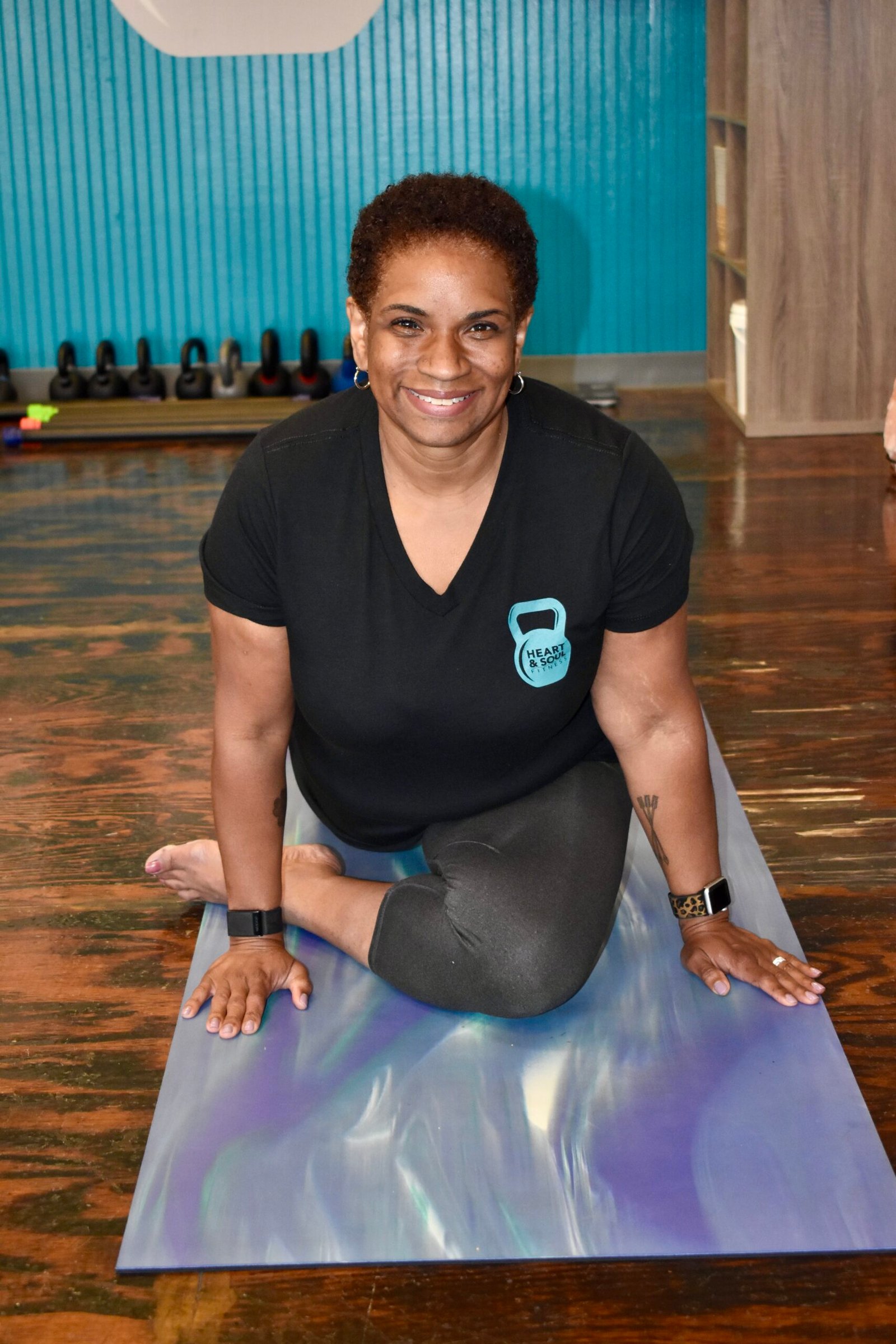 a woman stretching on a yoga mat